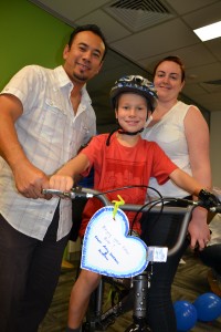 Child receives bike built by corporate teams